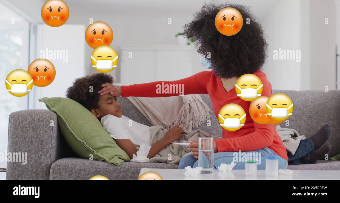Biracial mother checking on her son lying on couch, both looking tired Stock Photo