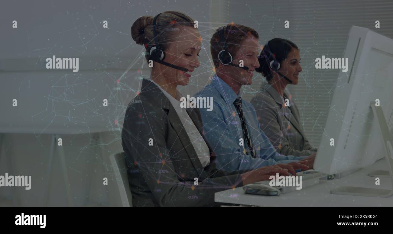 Caucasian group wearing headsets, working on computers Stock Photo