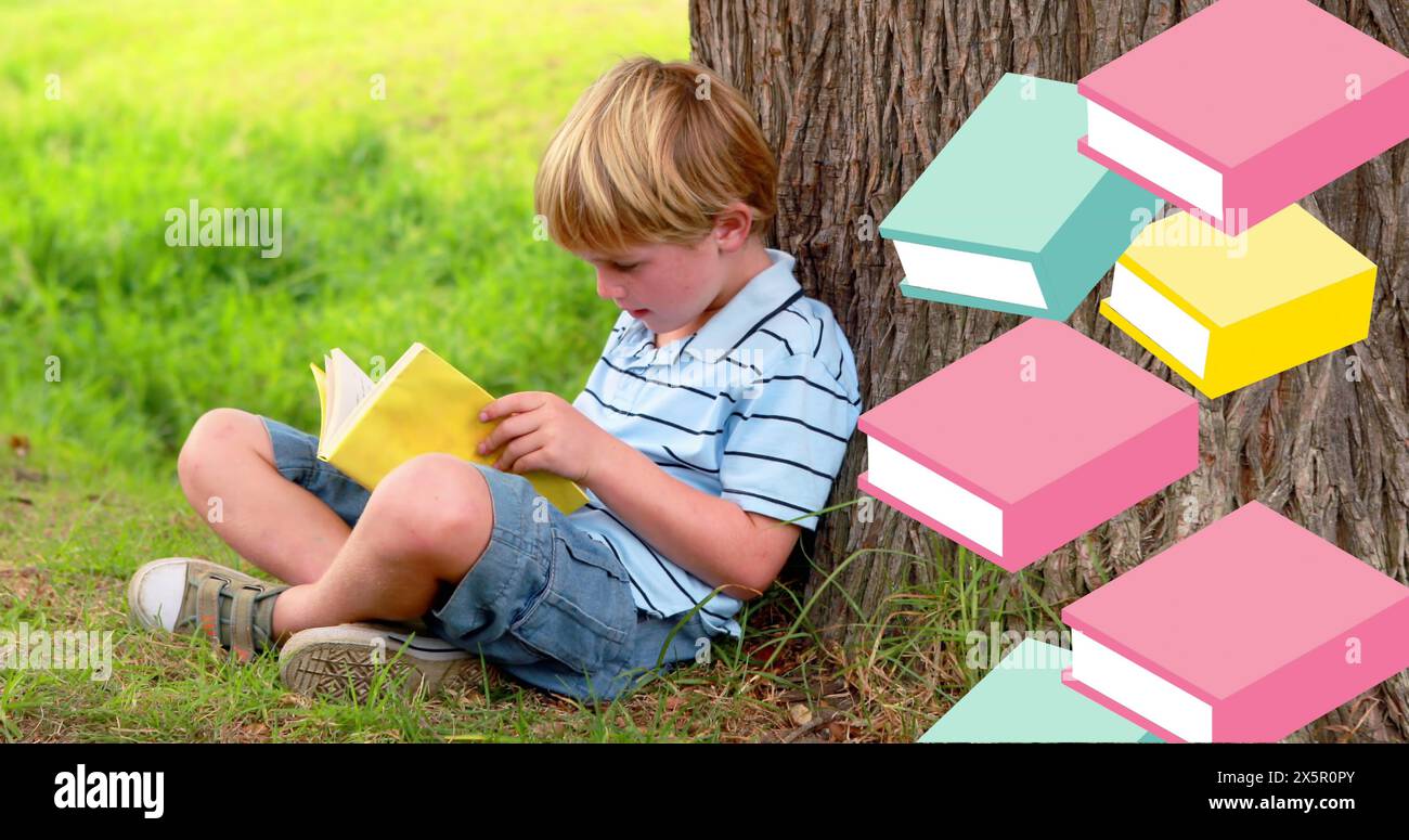 Image of books moving over boy reading book leaning against tree Stock ...