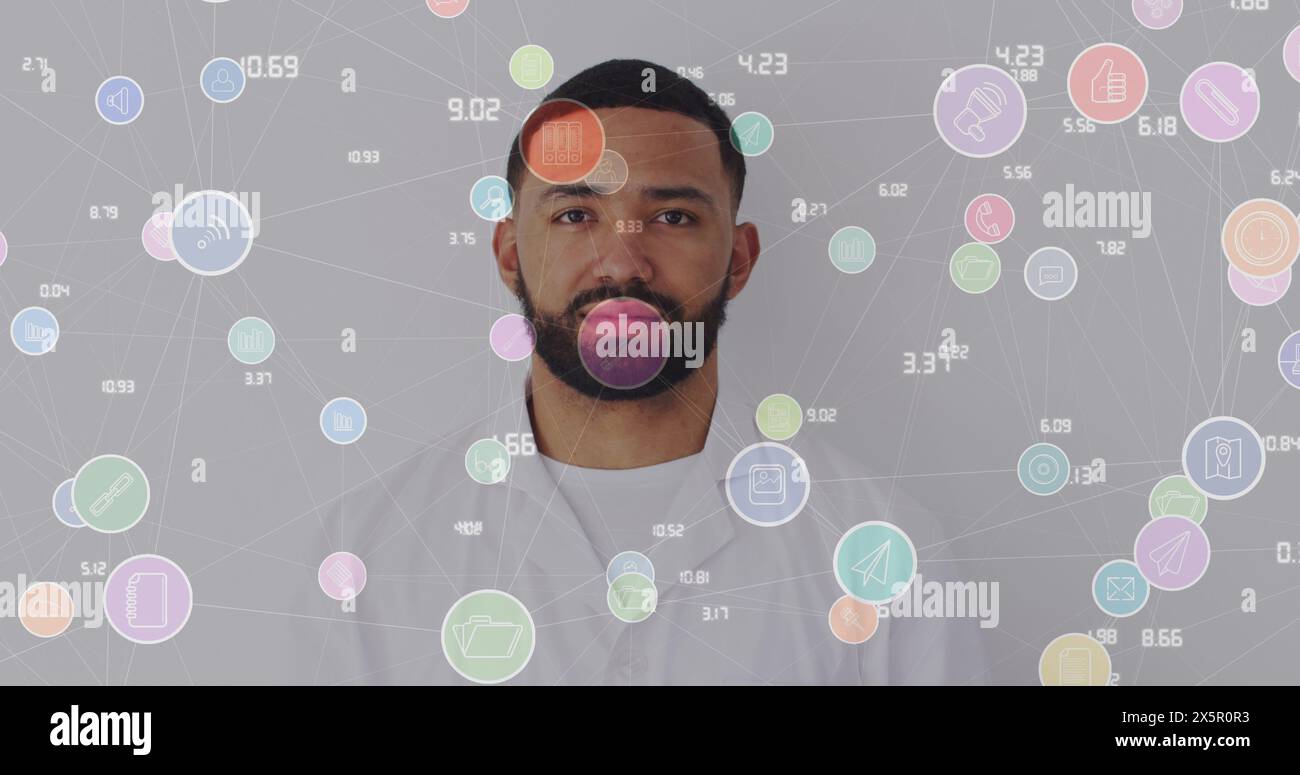 Image of network of connections with icons over biracial man smiling at ...