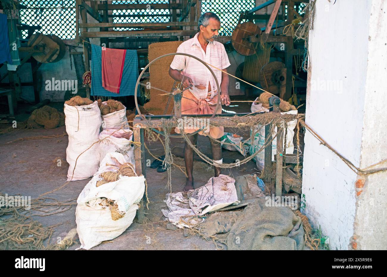Indian worker winding coils in the Labourers Coir Mats and Mattings