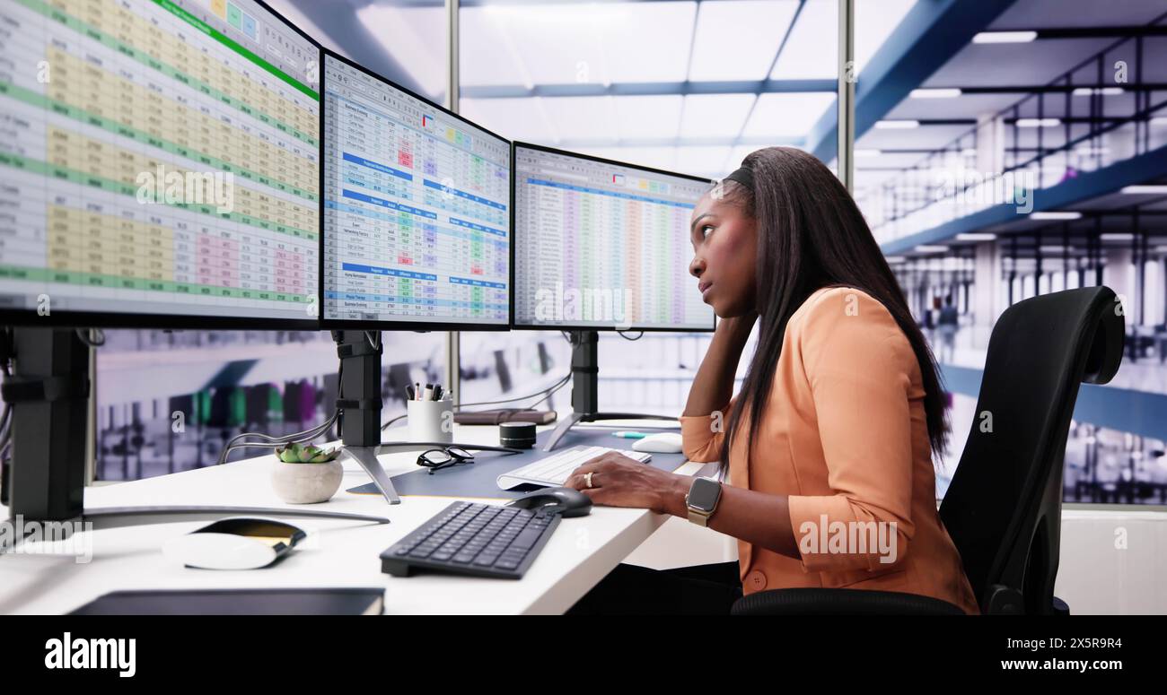 Data Analyst African Woman Using Spreadsheet On Computer Stock Photo