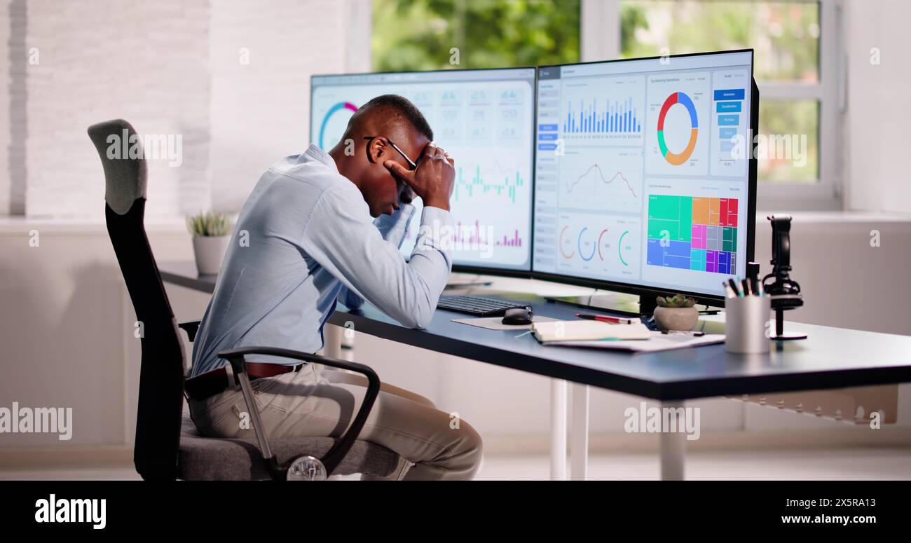 Data Analyst African Man Using Spreadsheet On Computer Stock Photo