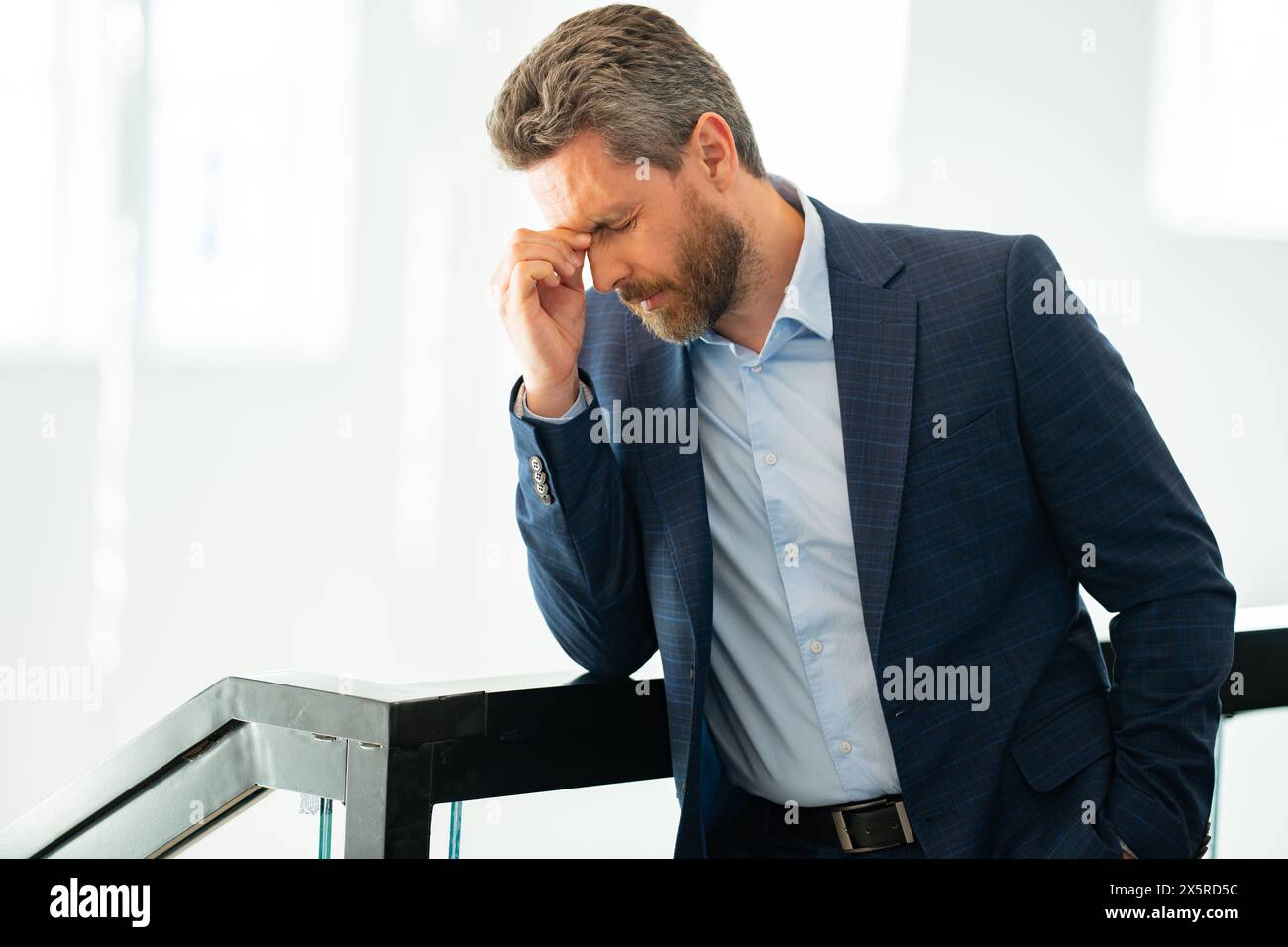 Relieving A Problem Tired man suffering from headache, touching head, relieving pain ...