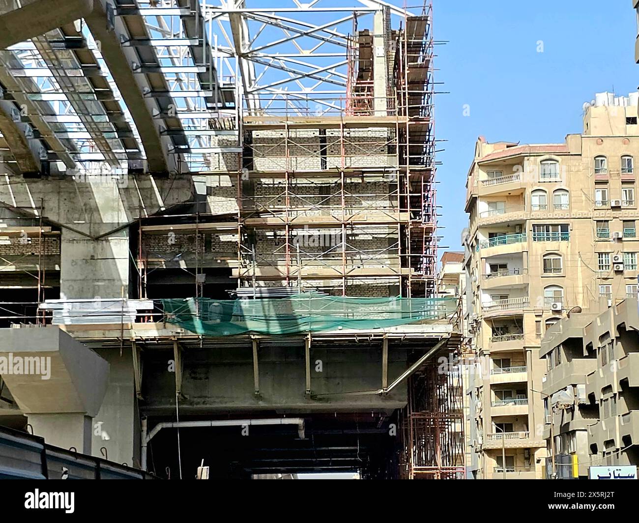 Cairo, Egypt, April 24 2024: A monorail station site that is under construction with scaffolds and crane, Cairo monorail is a two-line mono rail rapid Stock Photo