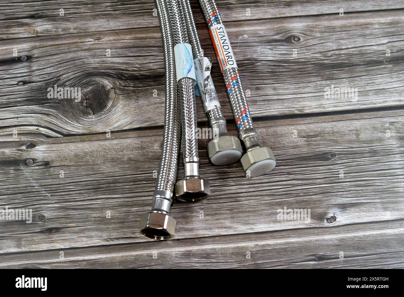 Cairo, Egypt, April 16 2024: water tube pipelines, braided flexible water hoses, replacement and maintenance plumbing concept and home services, Braid Stock Photo