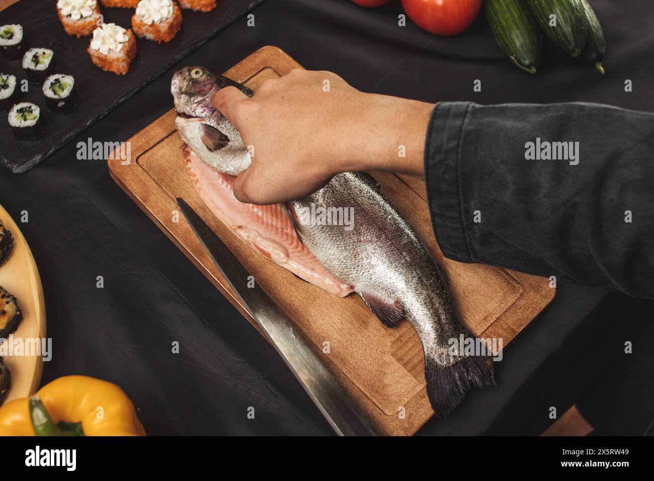 Cropped Image Fish make cleaning and filleting a fresh cought fish. close up top view ...