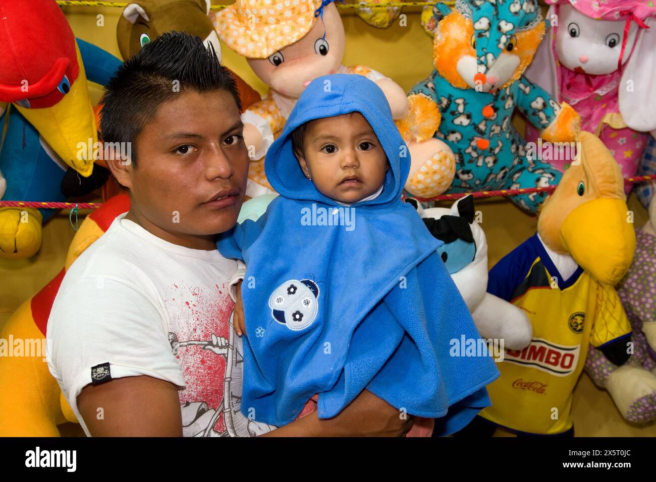 Oaxaca, Mexico, North America.  Day of the Dead Celebrations.  Mother and Daughter at Stuffed Animal Stand outside entrance to San Miguel Cemetery. Stock Photo