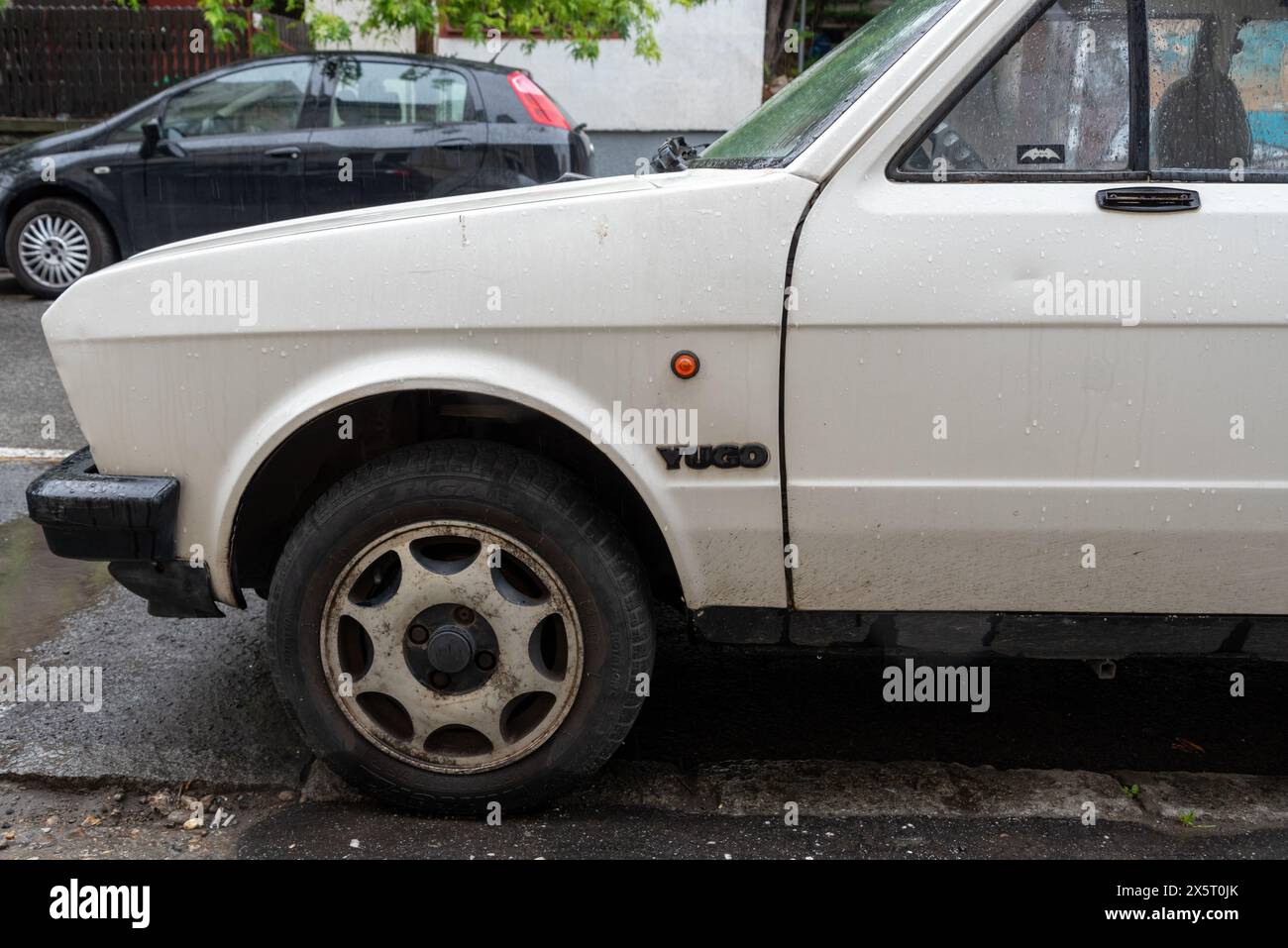 Close up of the side of a Yugo car on the streets of Belgrade, classic car made in Yugoslavia. may 2024 Stock Photo