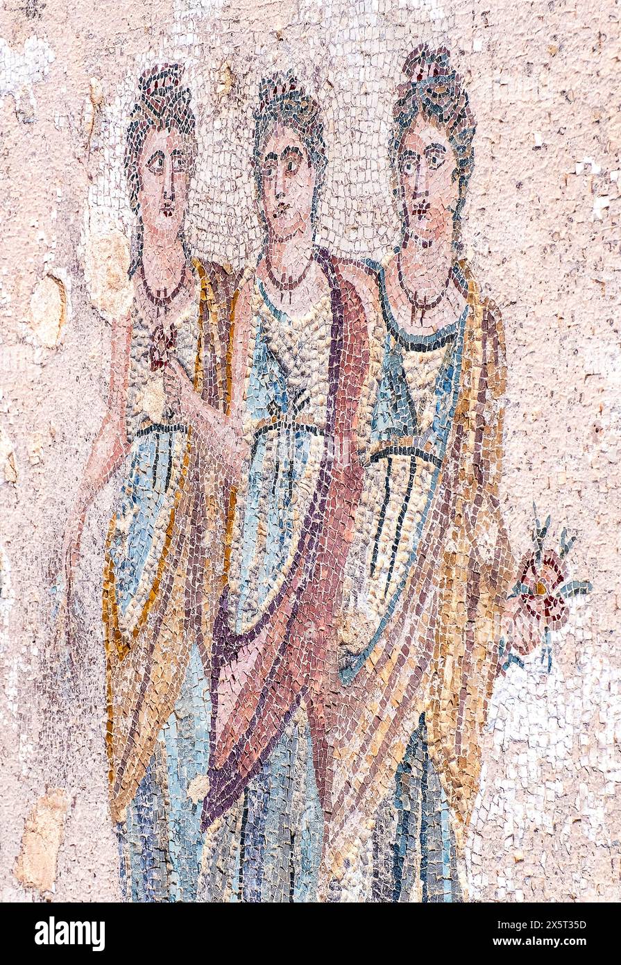 The Three Horae Mosaic. This central mosaic floor depicts the Three Horae on a white background by a catenary tress zone. Paphos Archaeological park. Stock Photo