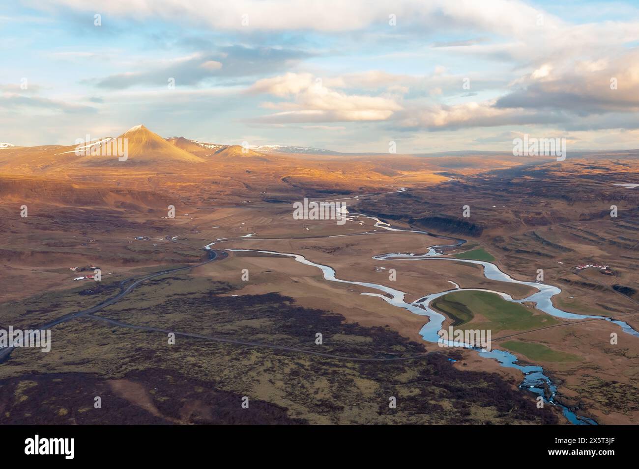 Scenic dron view winding river flowing through meadow in spring. After sunset. Borgarnes Iceland. Stock Photo