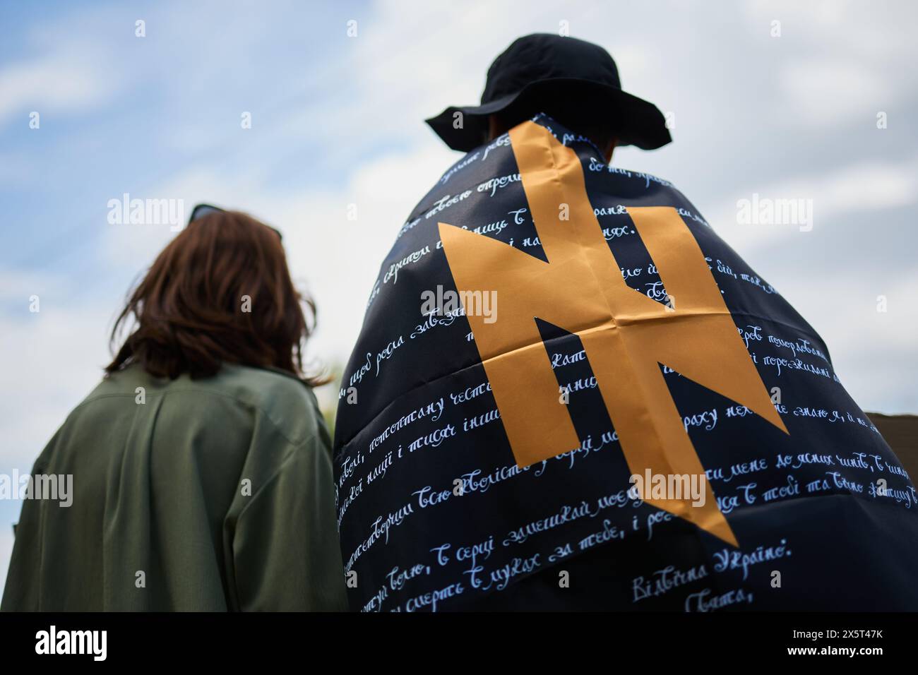 Ukrainian activist wearing a flag of Azov brigade and a prayer of ...