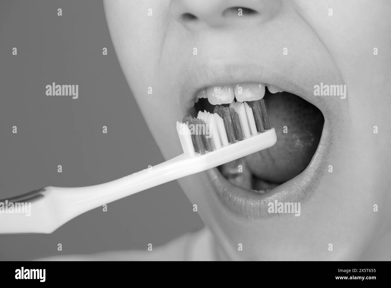 Dental hygiene. Little kid brushing her teeth. Kid boy brushing teeth. Health care, dental hygiene. Child shows toothbrushes. Bad teeth child Stock Photo