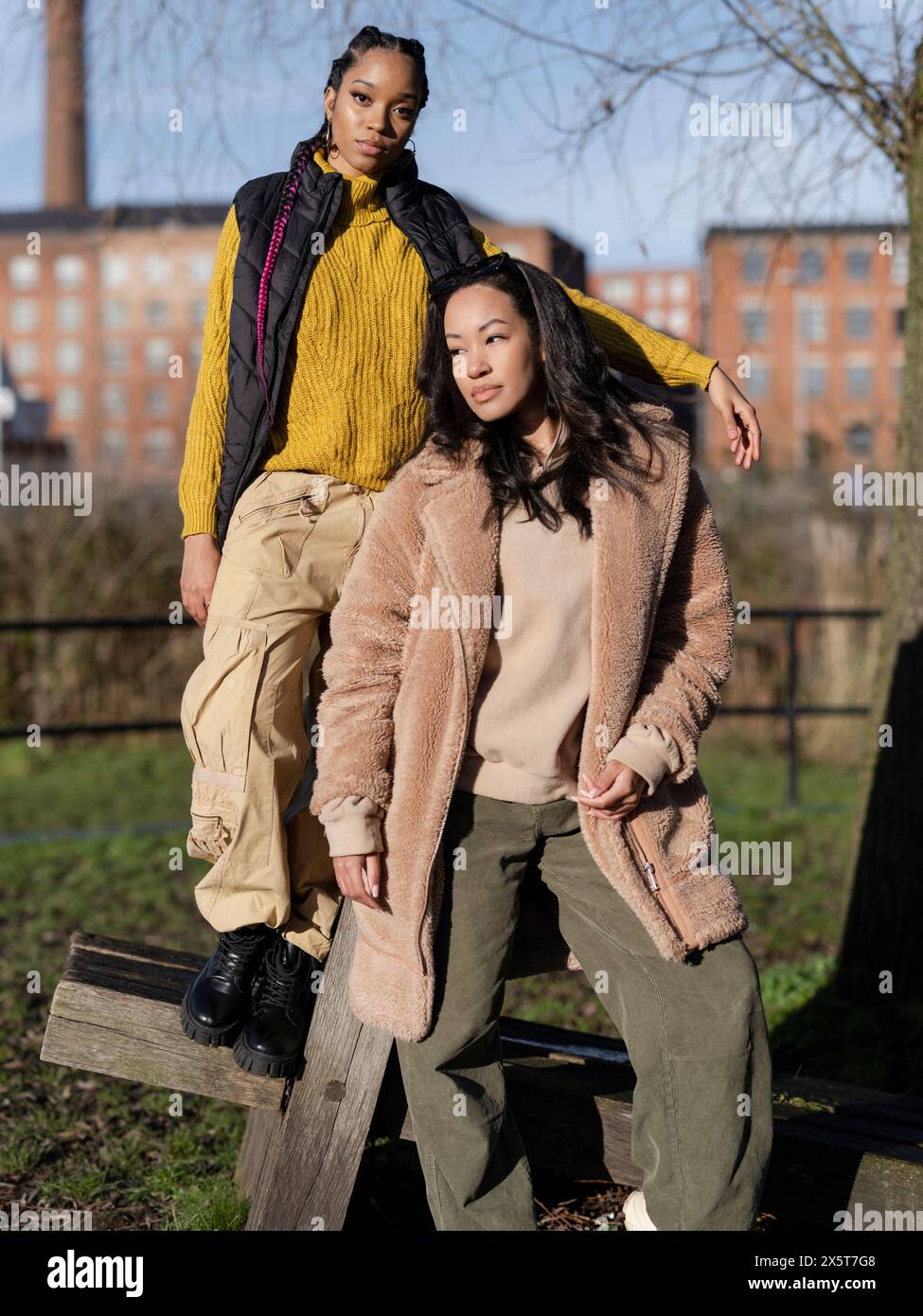 Two young women posing for portrait in park Stock Photo - Alamy