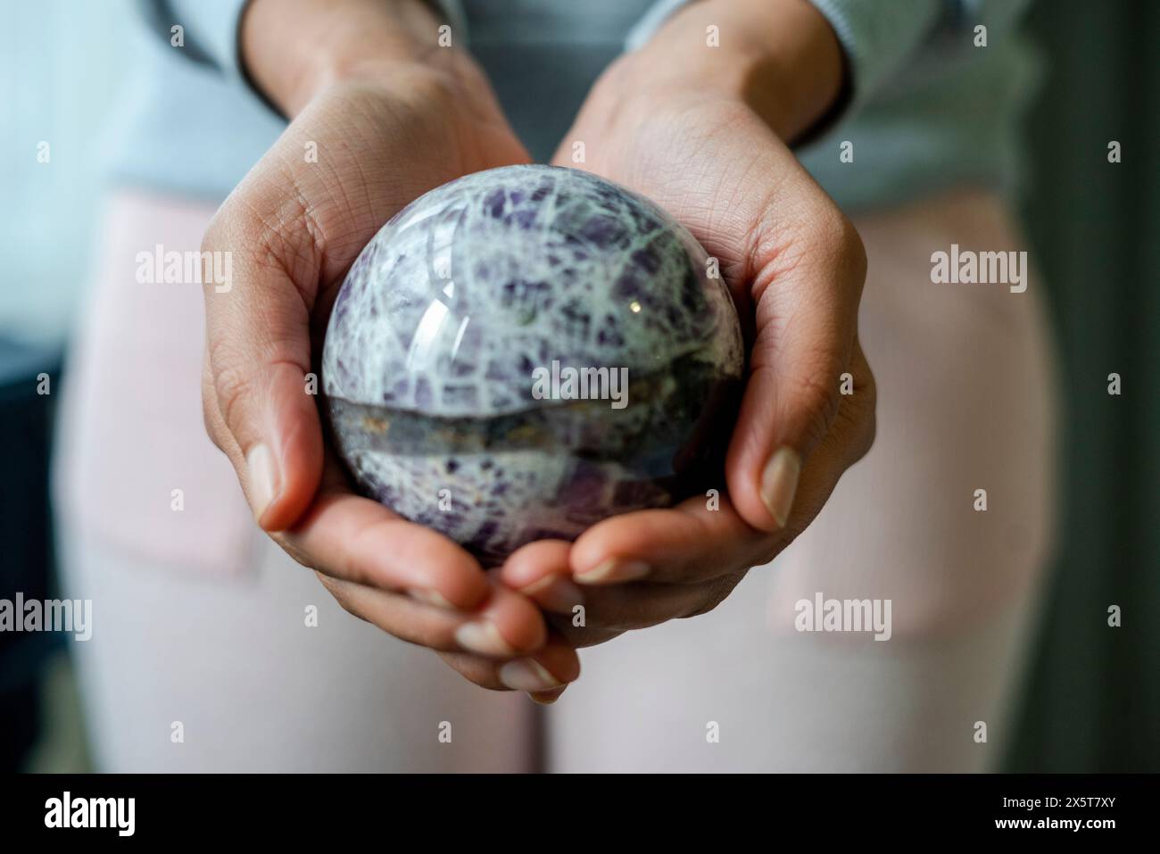 Close-up of female hands holding crystal ball Stock Photo - Alamy