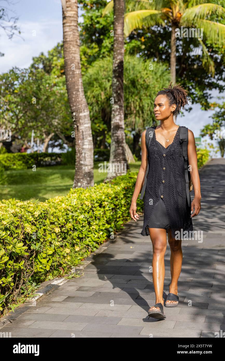 Bali, Indonesia, Female tourist walking on sunny day Stock Photo