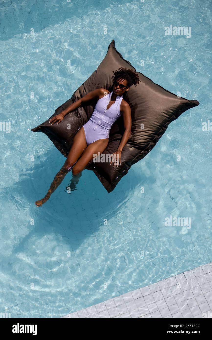 Overhead view of woman relaxing in swimming pool Stock Photo