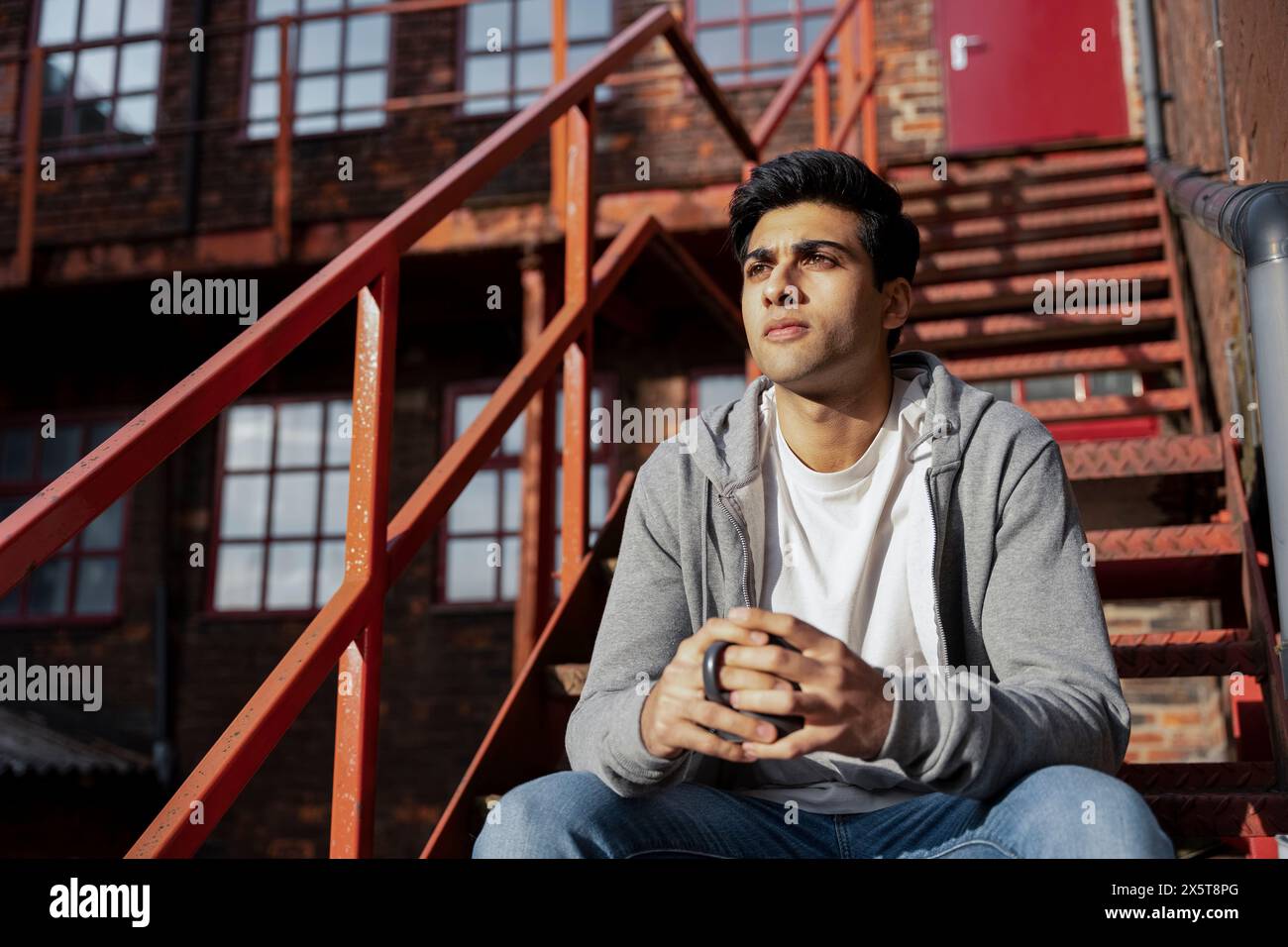 Man sitting on staircase hi-res stock photography and images - Alamy