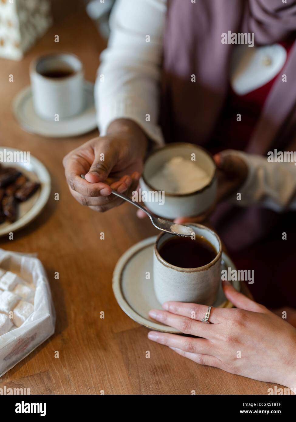 Hand adding sugar in cup hi-res stock photography and images - Alamy