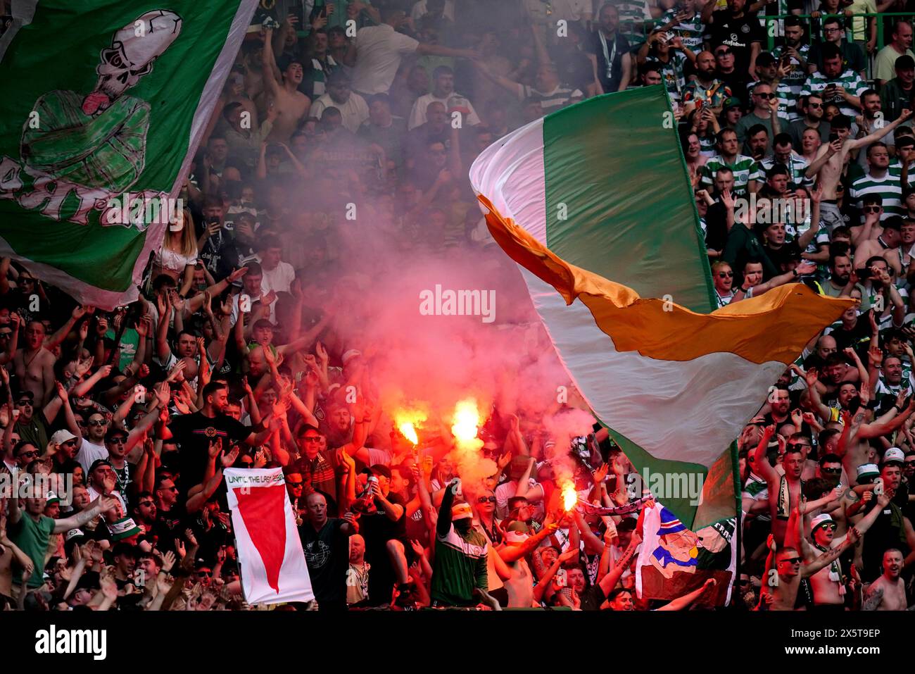 Celtic fans let off smoke flares during the cinch Premiership match at Celtic park, Glasgow. Picture date: Saturday May 11, 2024. Stock Photo