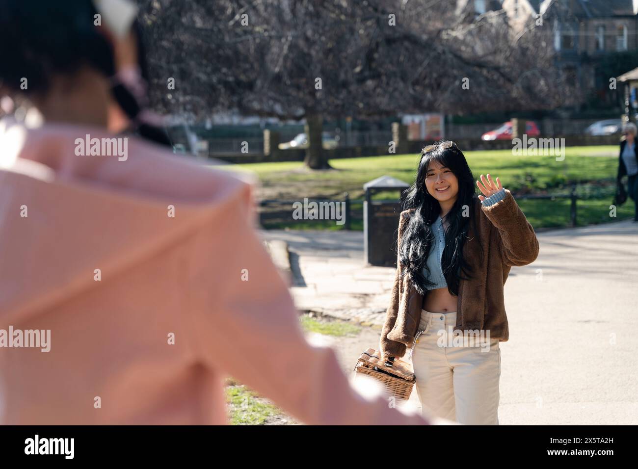Young people greeting friend hi-res stock photography and images - Alamy