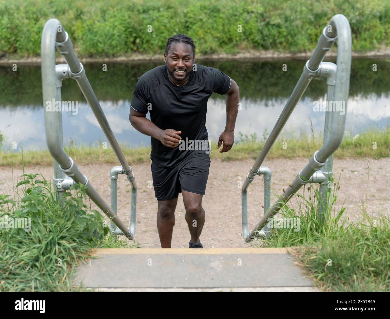 Black man running up stairs hi-res stock photography and images - Alamy