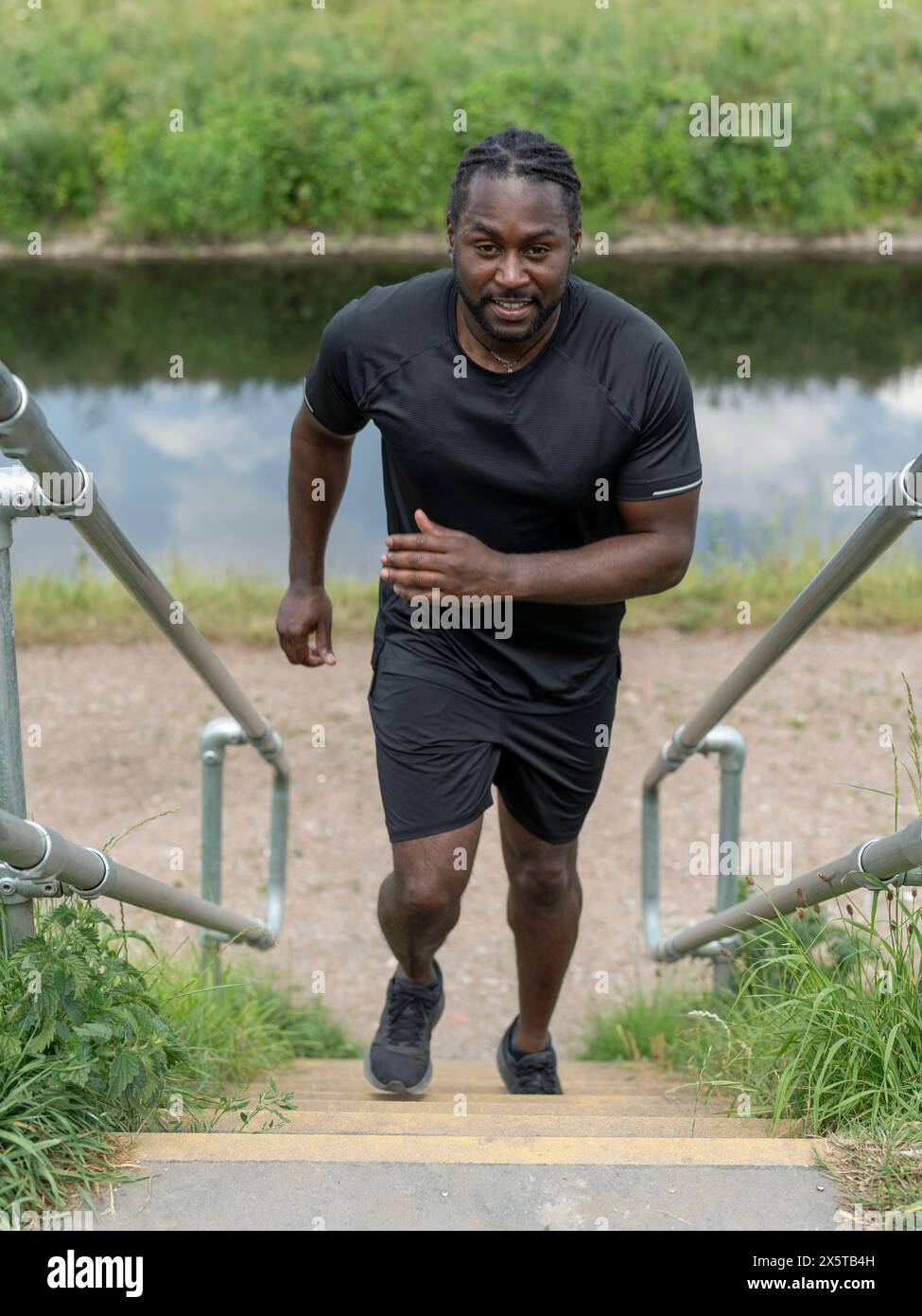 Black man running up stairs hi-res stock photography and images - Alamy