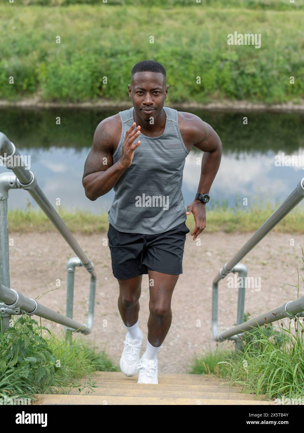 Black man running up stairs hi-res stock photography and images - Alamy