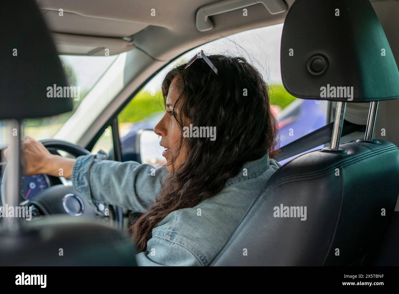 Mid adult woman driving car Stock Photo