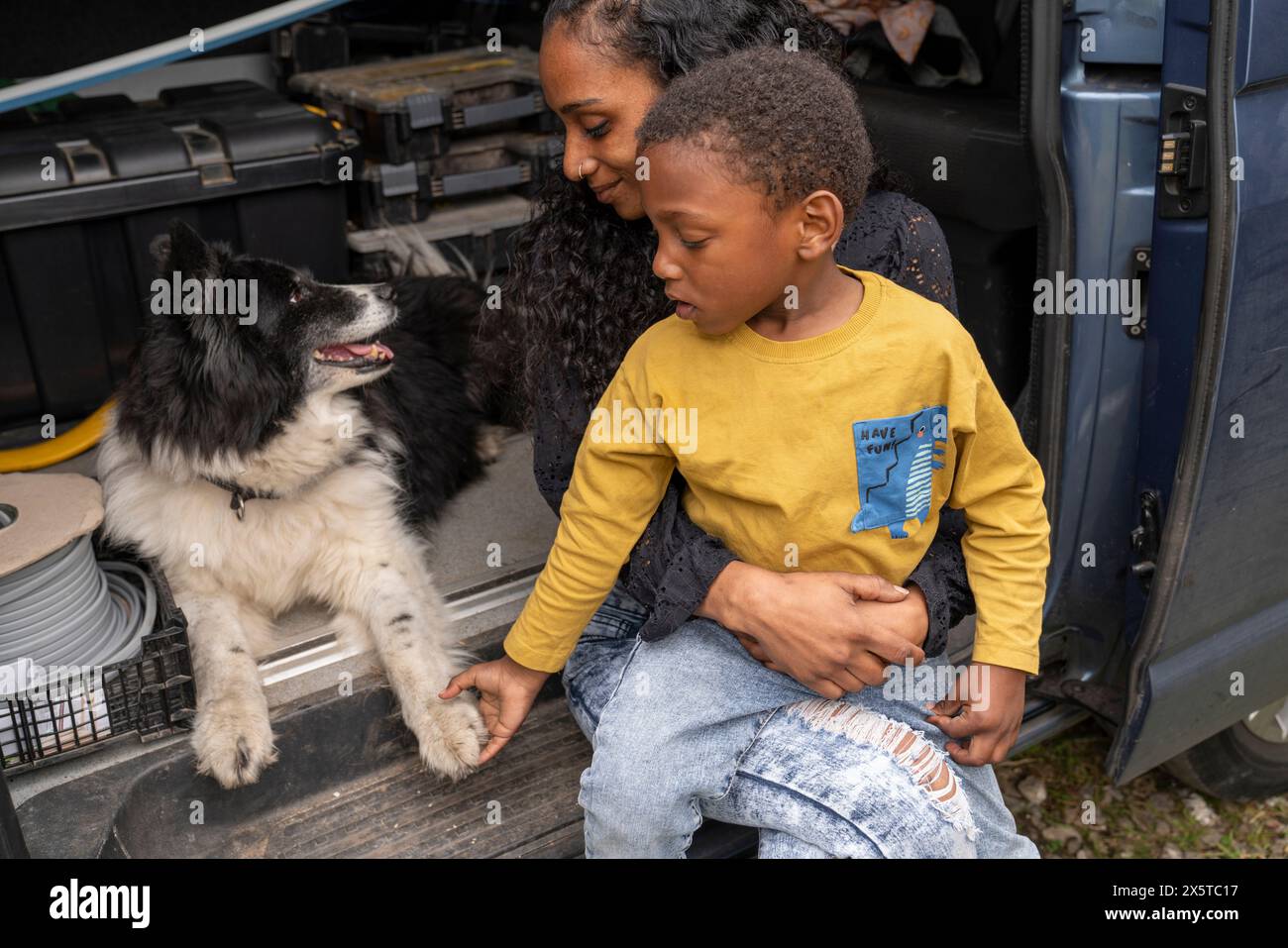 Mother with son and dog in van preparing for trip Stock Photo