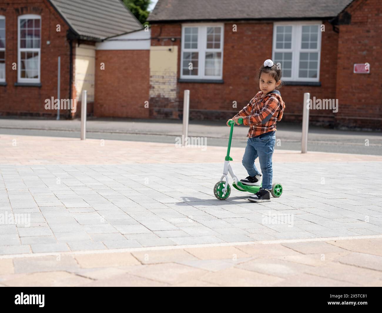 Portrait of boy (2-3) riding push scooter Stock Photo