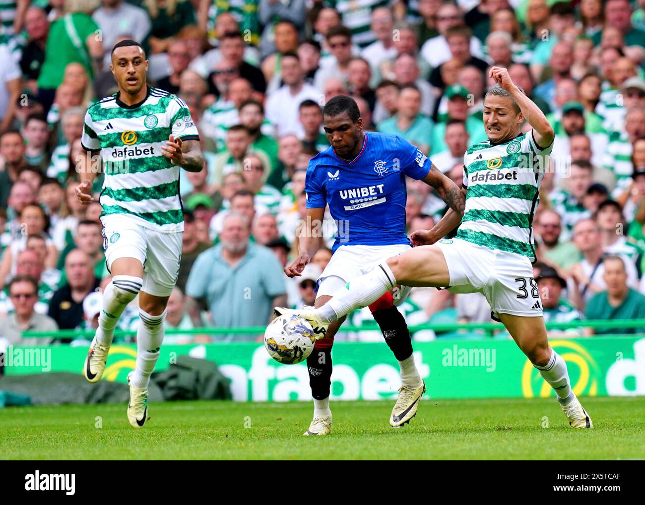 Celtic's Daizen Maeda (right) and Rangers' Dujon Sterling battle for the ball during the cinch Premiership match at Celtic park, Glasgow. Picture date: Saturday May 11, 2024. Stock Photo