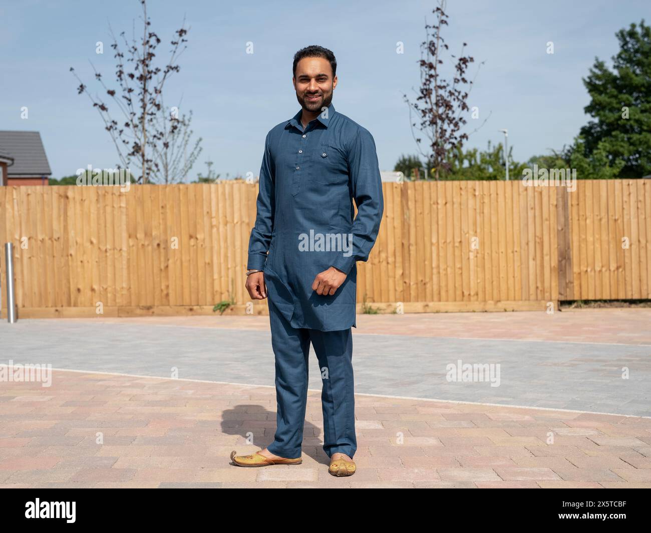 Portrait of smiling man in traditional clothing Stock Photo - Alamy