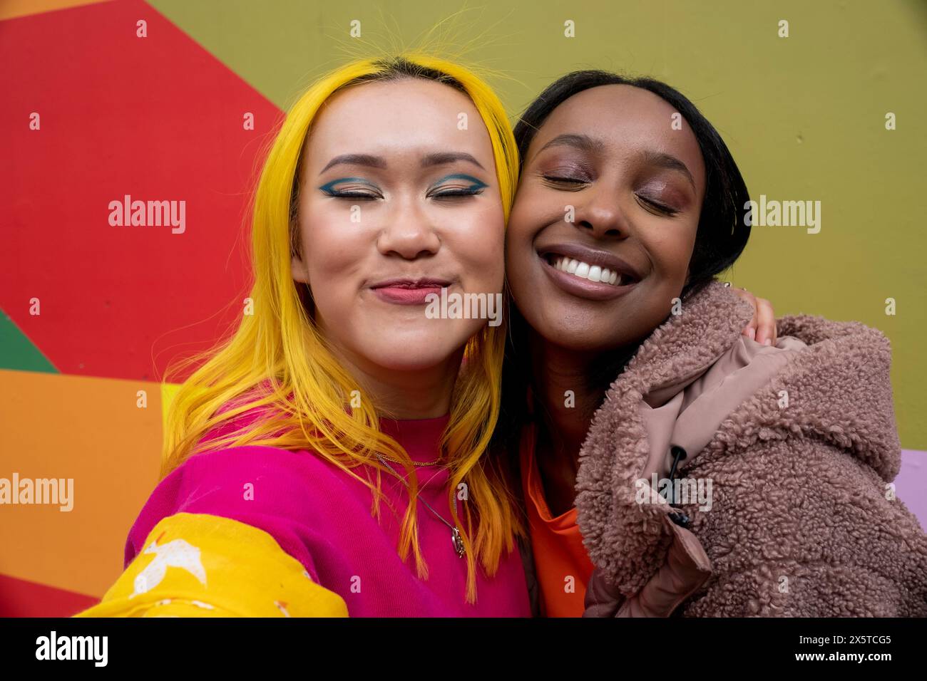 Young friends hugging smiling hi-res stock photography and images - Alamy