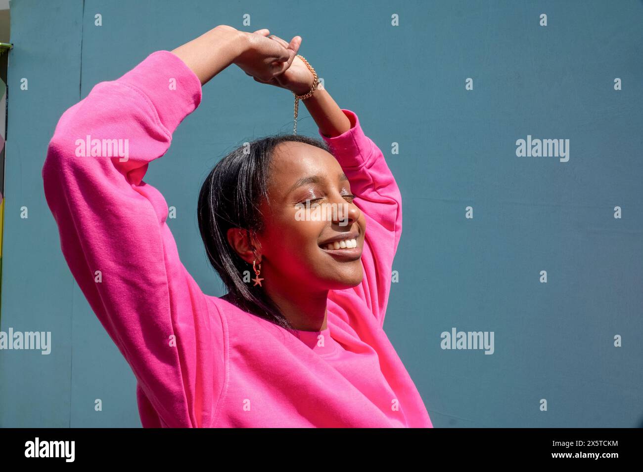 Woman holding up arms hi-res stock photography and images - Alamy