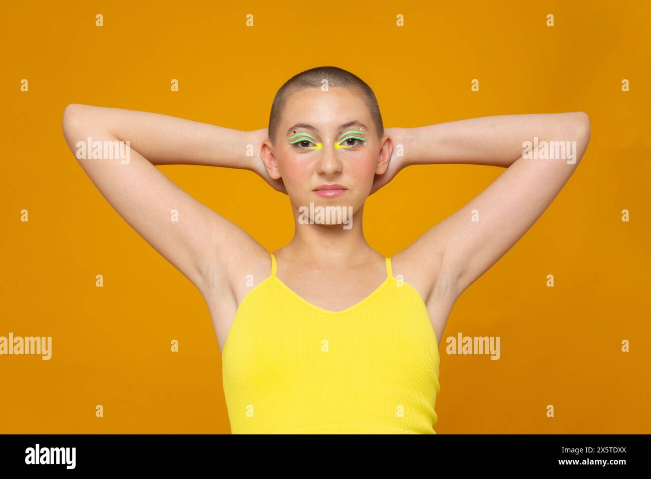 Studio portrait of girl with neon colored make-up Stock Photo