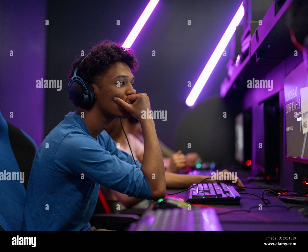 Young man playing video games in gaming club Stock Photo