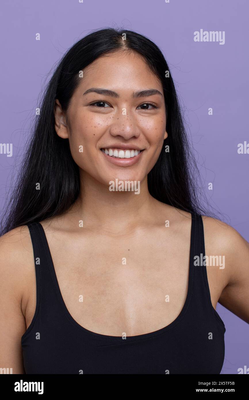 Portrait of smiling woman with black hair Stock Photo