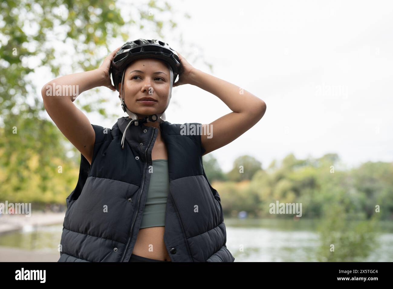 Woman wearing cycling helmet hi-res stock photography and images - Alamy