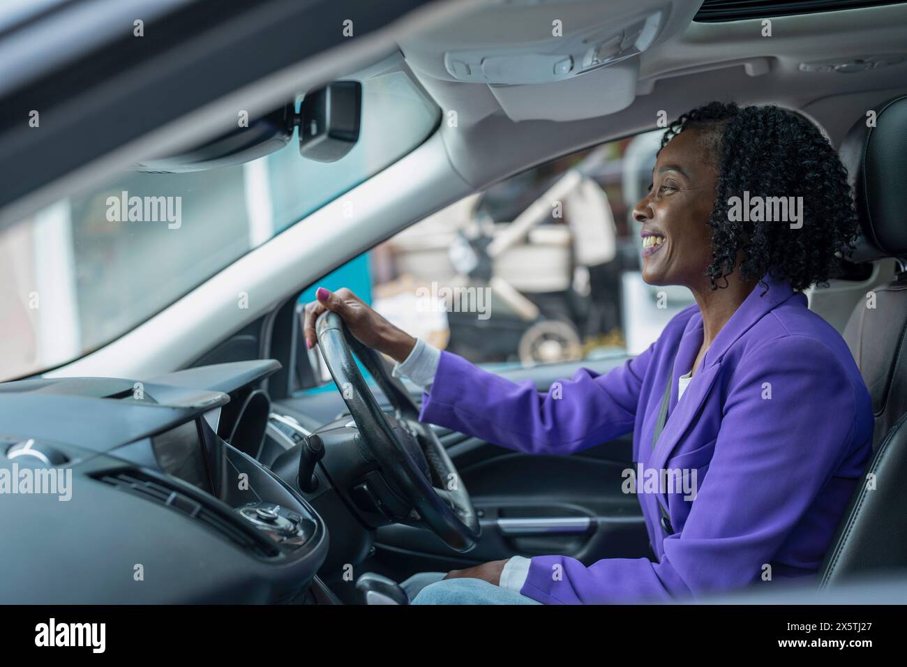 Confident woman driving car Stock Photo - Alamy