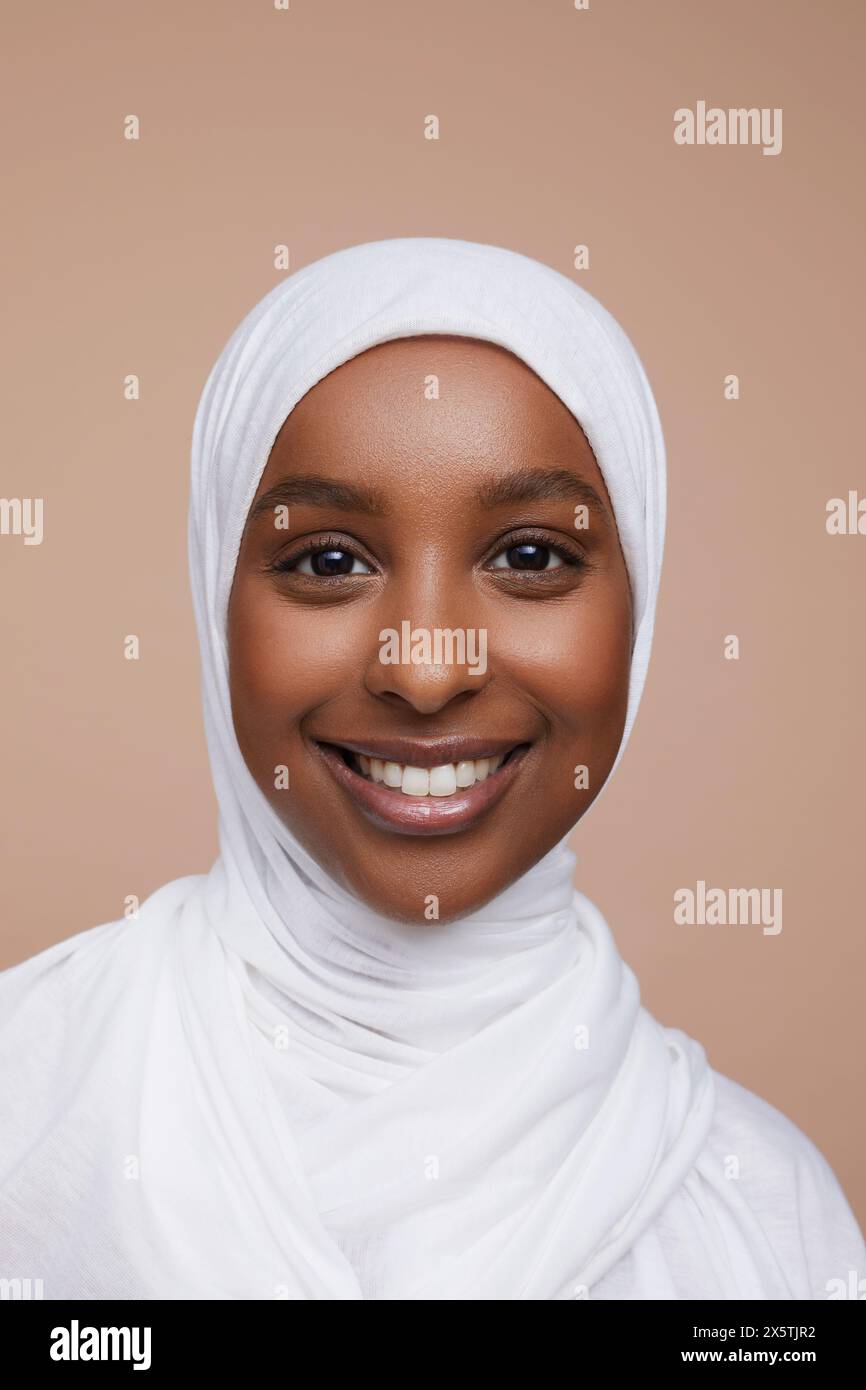 Studio portrait of smiling young woman wearing white hijab Stock Photo ...
