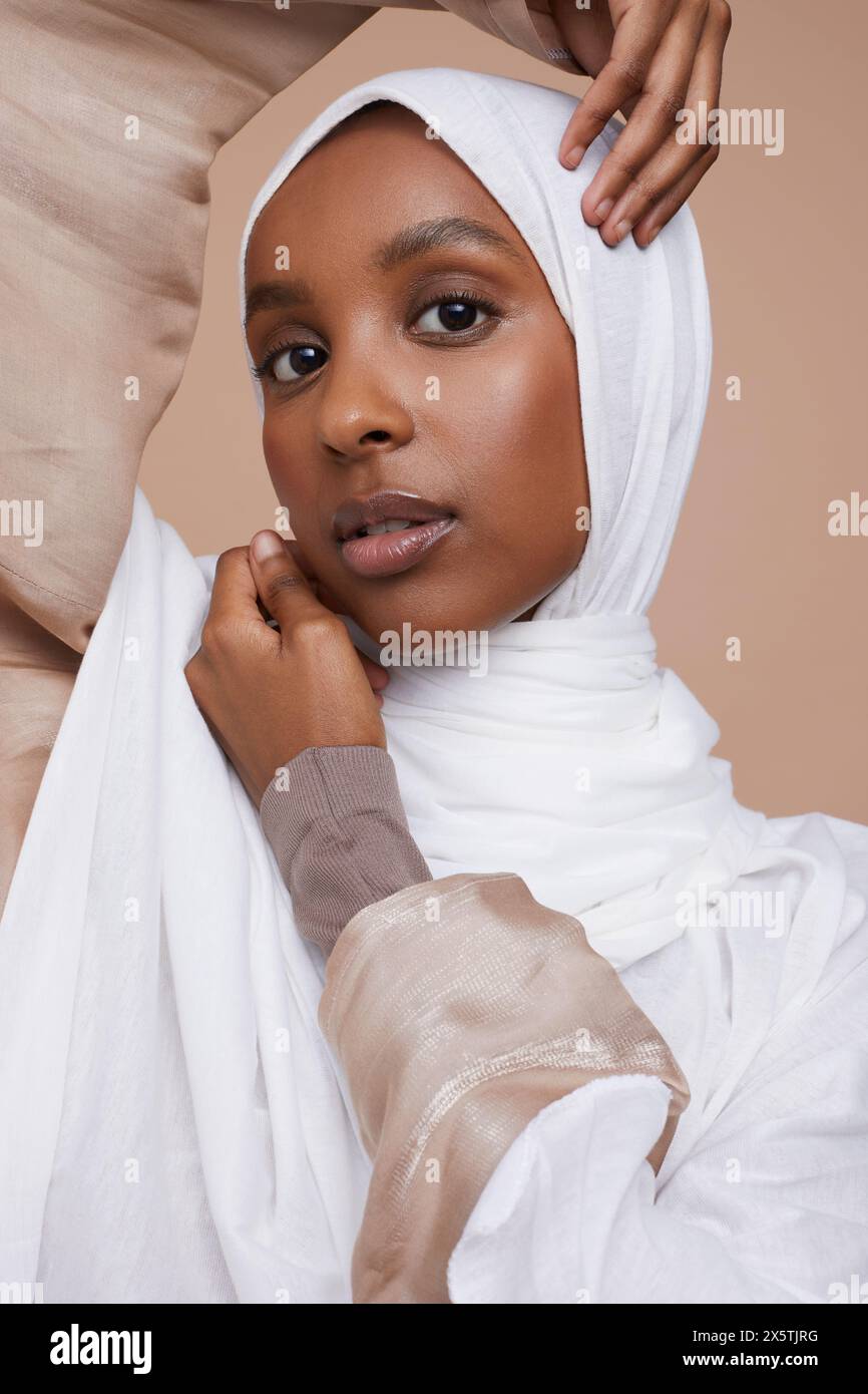 Studio portrait of young woman wearing white hijab Stock Photo - Alamy