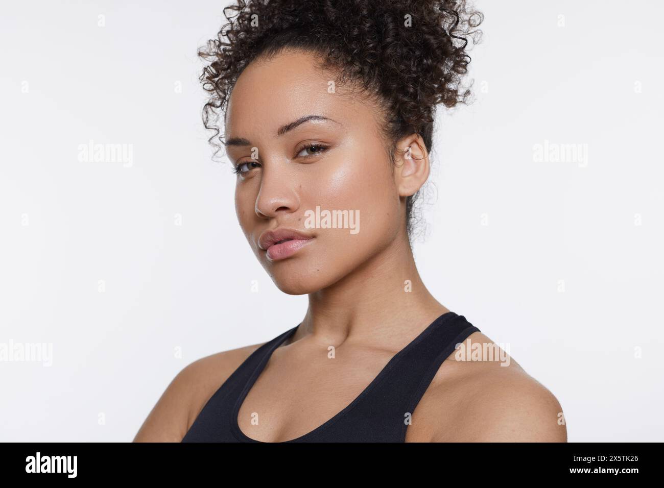 Studio portrait of athletic woman in black top Stock Photo