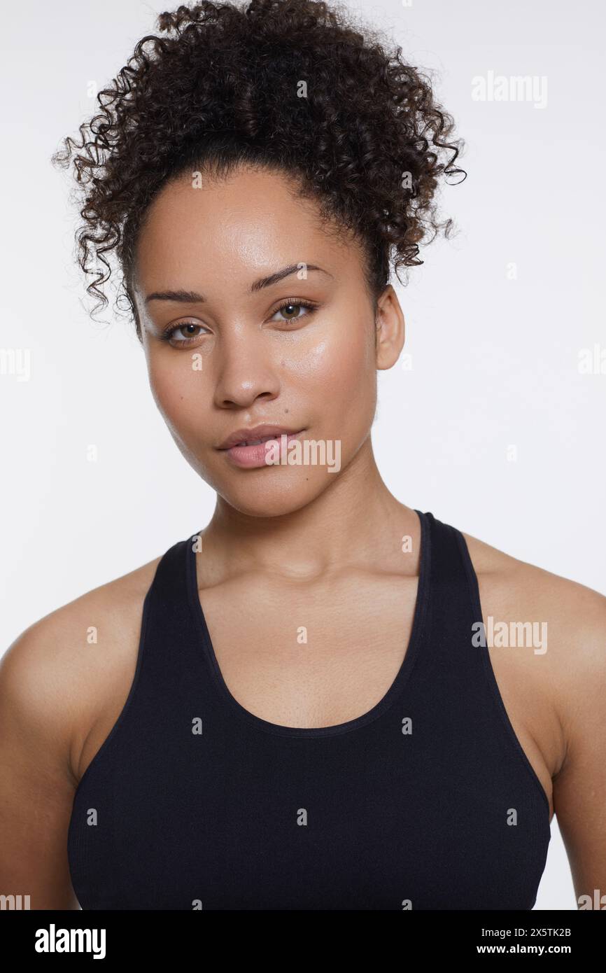 Studio portrait of athletic woman in black top Stock Photo