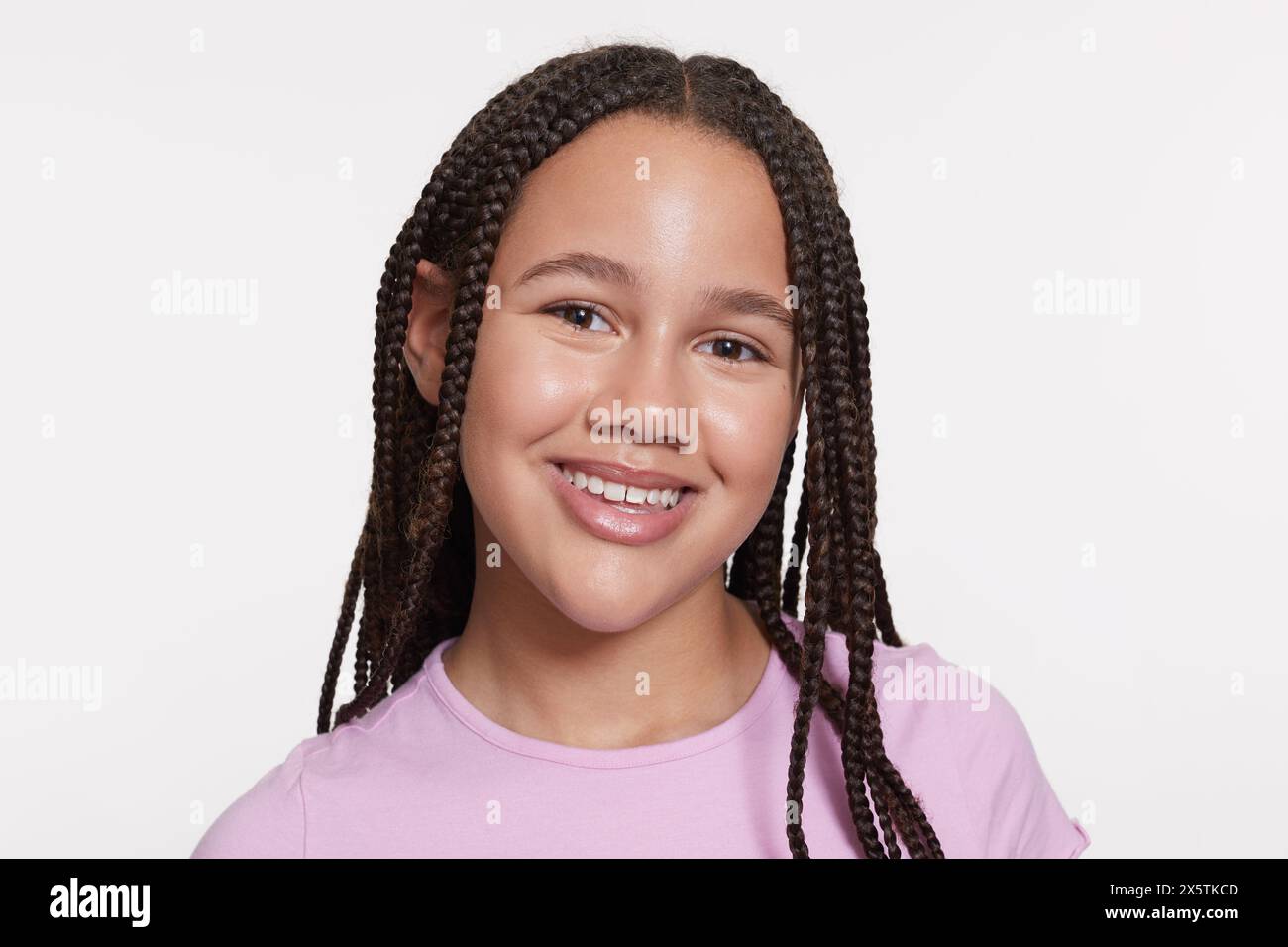 Studio portrait of smiling girl with braided hair Stock Photo - Alamy