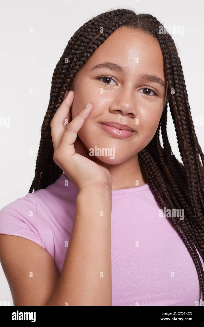 Studio portrait of smiling girl with braided hair Stock Photo - Alamy