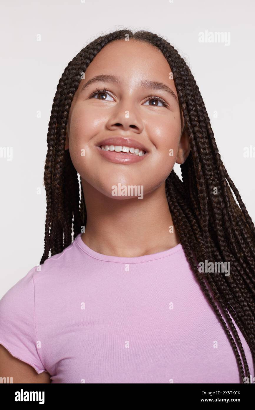 Studio portrait of smiling girl with braided hair Stock Photo - Alamy