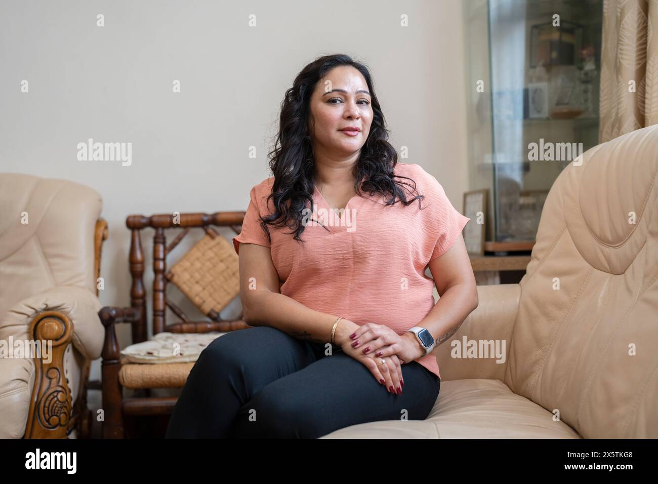 Mature woman sitting on sofa hi-res stock photography and images - Alamy