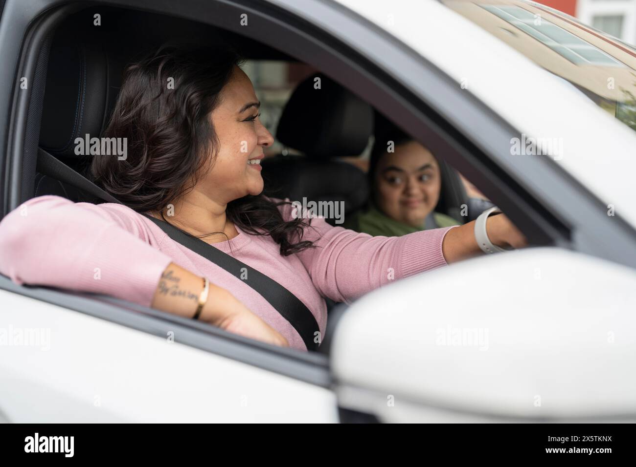 Mother driving car with down syndrome daughter Stock Photo Alamy