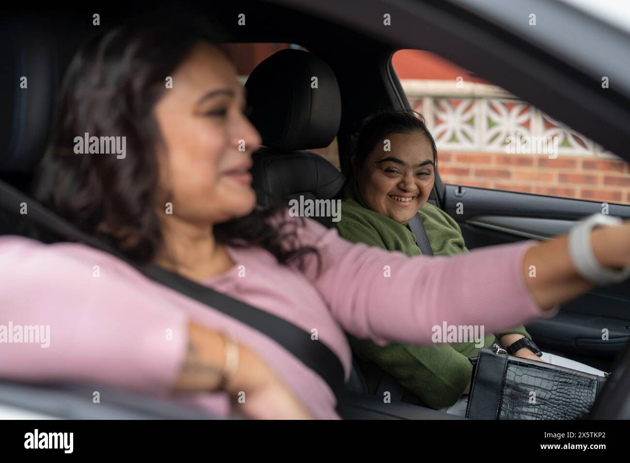 Mother driving car with down syndrome daughter Stock Photo Alamy